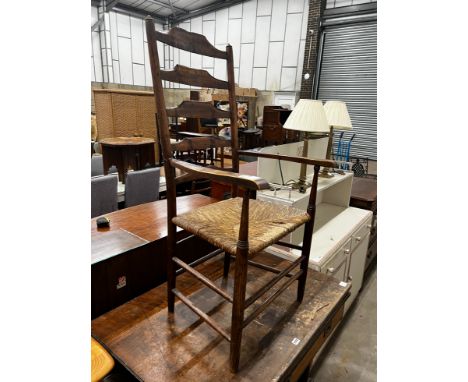 A 19th century provincial ash and elm rush seat ladder back elbow chair, width 59cm, depth 40cm, height 116cm