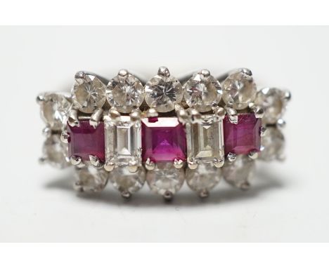A modern 18ct white gold, square cut ruby and round and baguette cut diamond set cluster ring, size L, gross weight 3.9 grams