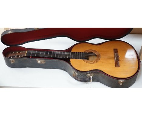A Harald Petersen classical concert guitar, paper label interior, with hard case. Length of back 49cm excluding button