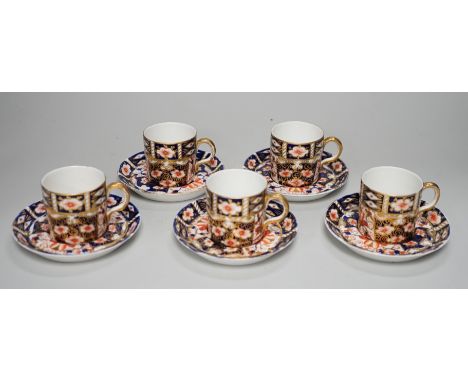 Five Royal Crown Derby Imari coffee cans and saucers