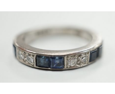 A modern 18ct white gold, six stone sapphire and four stone diamond set half eternity ring, size M, gross weight 5.2 grams.