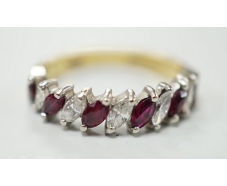 A modern 18ct gold and eleven stone marquise cut ruby and diamond set half hoop ring, size L, gross weight 3.5 grams.