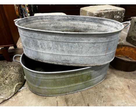 A pair of oval vintage galvanised zinc water troughs, length 104cm, depth 58cm, height 28cm together with a smaller circular 