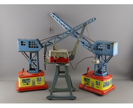 THREE TINPLATE TOY CRANES including two Western Germany clockwork examples and a Bandai Toys manual wind magnetic crane (vary