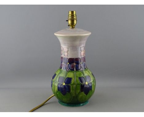 A MOORCROFT 'VIOLET' TABLE LAMP designed by Sally Tuffin, 32 cms high including fitting, impressed factory marks to the base