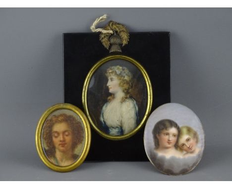 THREE PORTRAIT MINIATURES including a half length on ivory slip of Lady Hamilton, mounted in papier mache frame, a possibly G