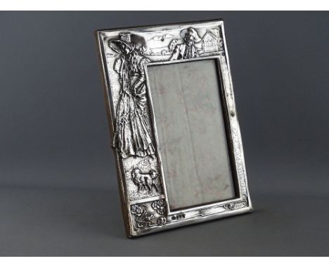 A SILVER REPOUSSE DECORATED EASEL PORTRAIT FRAME, Birmingham 1909, maker Israel Sigmund Greenberg, 26 x 18 cms