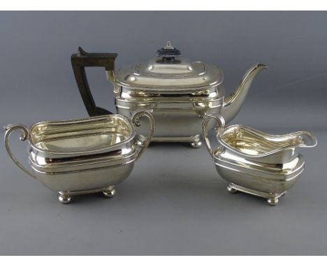 A THREE PIECE SILVER TEA SERVICE, each piece of oblong plain form with lined decoration on four ball supports, teapot with co