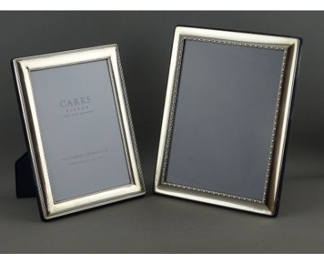 TWO MODERN HALLMARKED SILVER EASEL PHOTOGRAPH FRAMES, both rectangular form, 21.5 x 16 cms, Sheffield 2005 and 23.5 x 18.5 cm