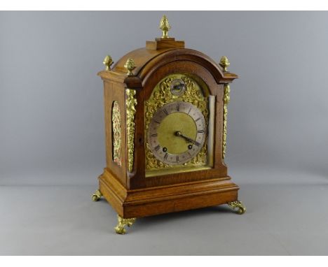 A FINE WINTERHALDER &amp; HOFMEIER CLOCK having an arched top, brass dial plate and gilt metal spandrels with silvered chapte