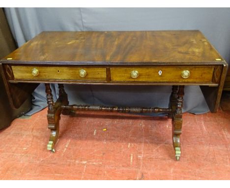 A REGENCY MAHOGANY TWIN FLAP SOFA TABLE having twin frieze drawers, opening to both sides, on turned supports with cross stre