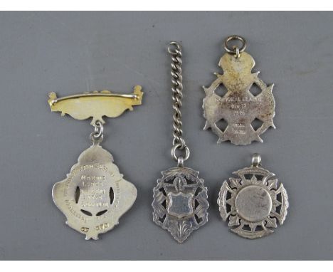 FOUR HALLMARKED SILVER PENDANT/WATCH FOBS including a Marine Lodge, no. 6619, Chester silver and enamel example, a Society Mi