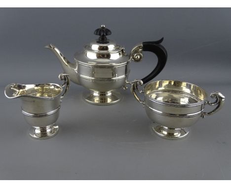 A THREE PIECE BACHELOR'S SILVER TEA SERVICE, pedestal form with scroll handles, Chester 1901, 12.4 troy ozs gross