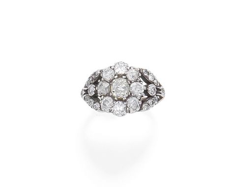 A diamond cluster ringThe floral cluster between bifurcated foliate shoulders, set throughout with cushion, old brilliant and