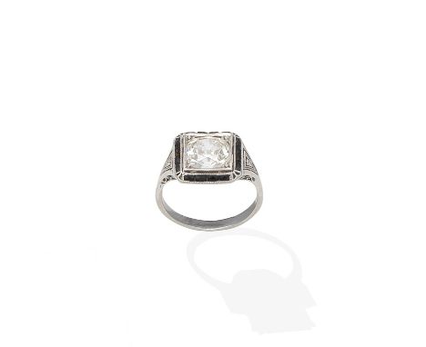 An Art Deco diamond and onyx ring, circa 1920The cushion-shaped diamond within a surround of French-cut onyx, between pierced