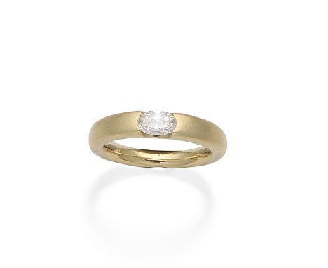 A diamond single-stone ringThe tapered brushed metal band horizontally-set with an oval-cut diamond, diamond very approx. 0.4