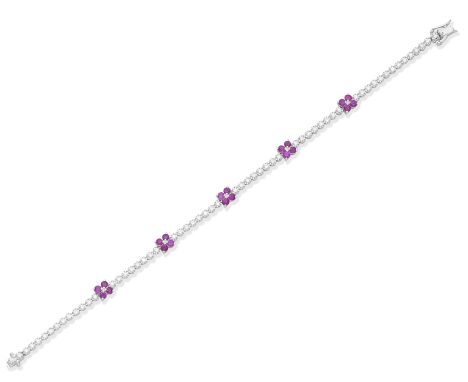 A ruby and diamond braceletDesigned as a row of brilliant-cut diamonds, set at intervals with circular-cut ruby flowerheads, 