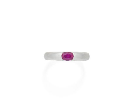 A ruby ringOf brushed finish, tension-set with an oval-cut ruby, ring size approx. Q½