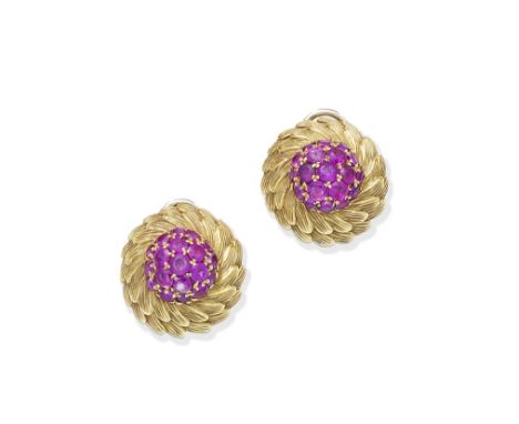 A pair of ruby and diamond earclips, circa 1960Each circular-cut ruby within a fluted bombé foliate surround, length 2.2cm