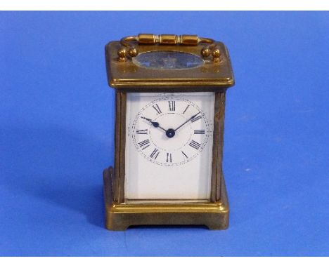 A French gilt-brass Carriage Clock, of five-glass form with hinged handle, the white dial with black Roman numerals, 5½in (14