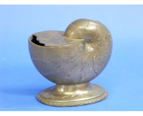 An antique pewter Spoon Warmer, in the form of a nautilus shell, together with an antique pewter candlestick (2)