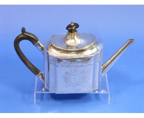 A George III Irish silver Teapot, hallmarks for Dublin but date letter absent, with bright cut decoration and ebonised wooden