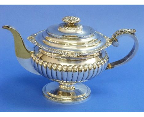 A George III Scottish silver Teapot, by John McDonald, hallmarked Edinburgh, 1816, of ovoid form with demi fluted decoration,