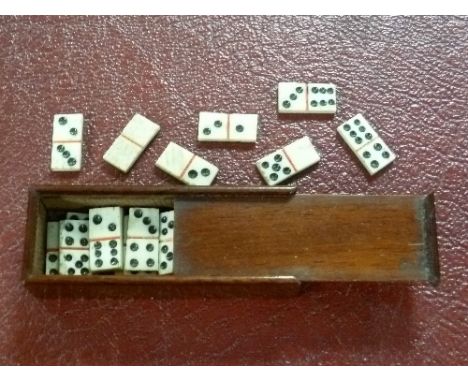 Dominoes; an antique set of twenty-eight miniature hand-carved bone dominoes, in mahogany box with sliding cover, dominoes ap
