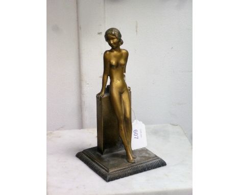 A French Art Deco spelter figural Table Lighter, modelled as a female nude leaning against a plinth, on a square base, the ba