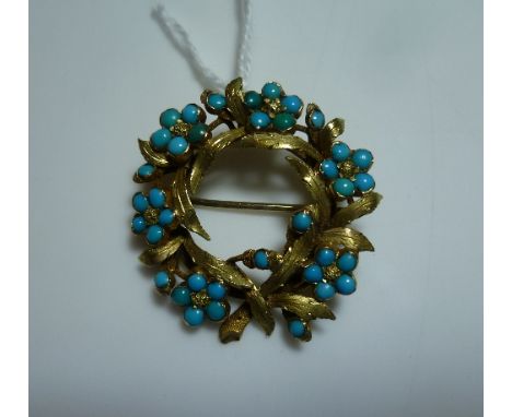 An openwork circle Brooch, with pendant suspension loop attached, formed of yellow gold textured leaves, with a surround of s