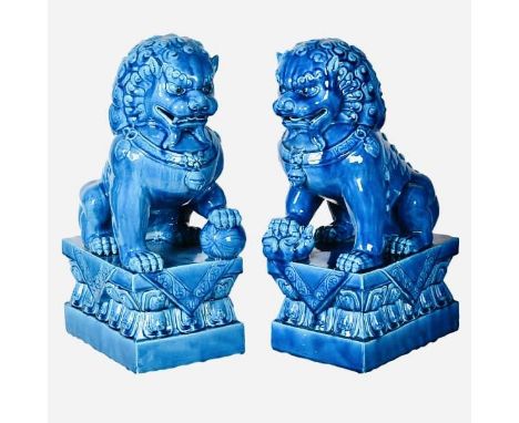 FOO DOGS, a pair, 39cm high, 15cm wide, 25cm deep, glazed ceramic. (2) 