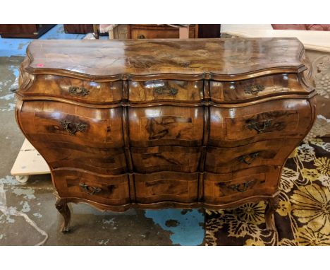 BOMBE COMMODE, 138cm W x 57cm x 91cm H, early 20th century Italian walnut and olivewood of serpentine form with three short a