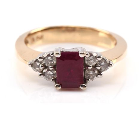 Ruby and diamond ring, with a central emerald-cut ruby, with three round brilliant cut diamonds each side, mounted in stamped