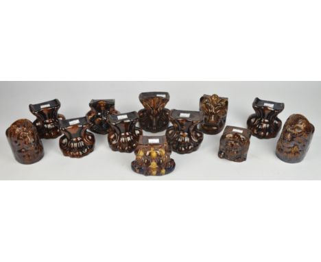 Seven Victorian stoneware sash window stops, each moulded with an amalier subject, the tallest 12cm and five matching Victori