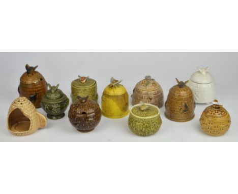 A pottery night light, in the form of a bee hive, together with Twenty two honey pots, mostly green and brown glazed, and two