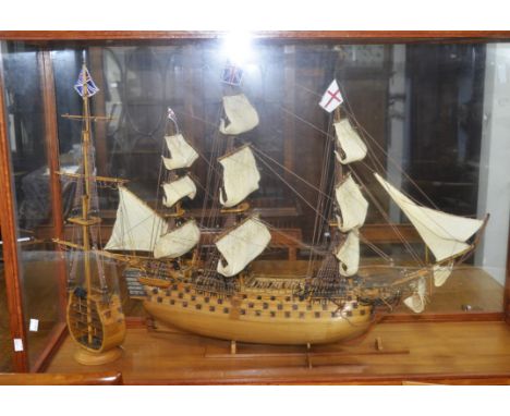 A glass cased scratch built model of H.M.S. Victory, together with a cross section smaller model, H79cm, W 127cm, D 40cm