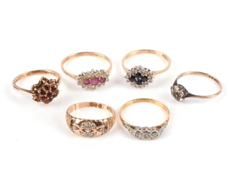 A group of six vintage rings, including a diamond three stone ring in stamped 18 ct size O, a ruby and paste cluster ring rin