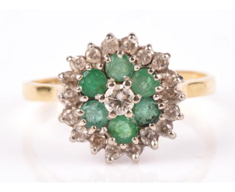 Emerald and brilliant cut diamond floral cluster ring, set with round brilliant cut diamonds and six round cut emeralds, moun