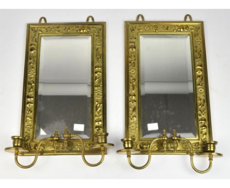 A pair of brass girandole wall mirrors, with fruit embossed wide borders and a rectangular bevelled plate. 38cm x 23cm (2)