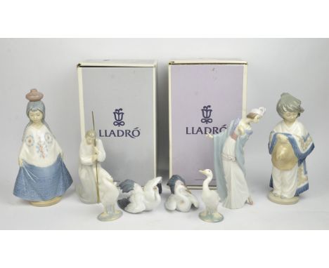 A collection of Lladro porcelain figures including ; Embroiderer, Landing Crane, The Flirt, eleven further Lladro porcelain f
