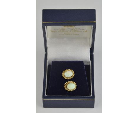 A pair of opal earrings, oval cabochon opal set within a rope design mount hallmarked 9ct Birmingham 1993, with post and butt
