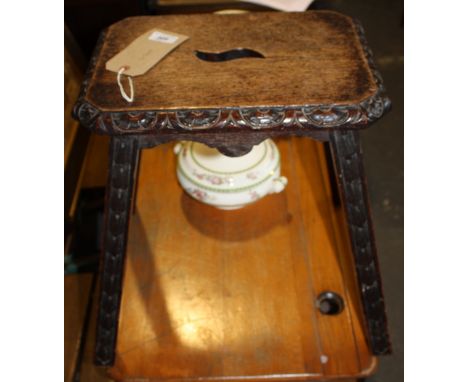 A Victorian carved oak stool.