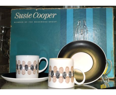 A Susie Cooper coffee service, comprising six cups and saucers, stylised thumbprint pattern, presented in original retail box