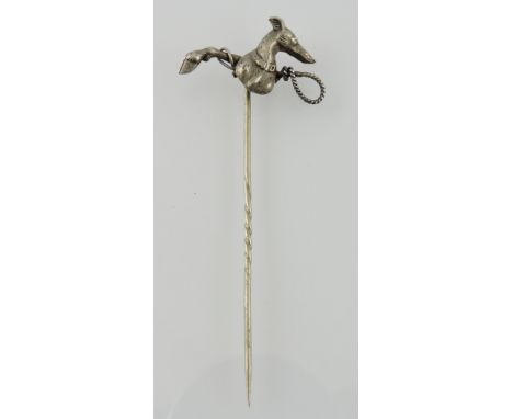 A white metal stock pin, cast in the form of a greyhound head together with whip and stag leg, 2g.