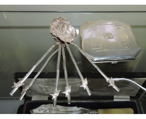 A George VI engine turned octagonal silver compact together with a set of six Japanese white metal teaspoons, with chrysanthe