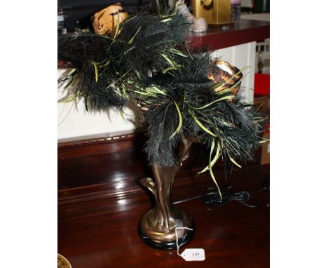 A twin-branch bronzed lamp in the Art Nouveau style, the figural support with fancy feathered shades, H. 54cm.