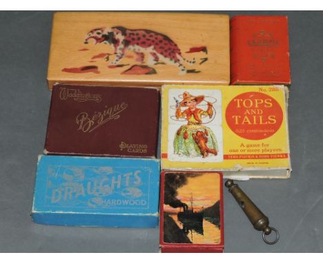 A quantity of card games, together with a cribbage board and dominoes. 