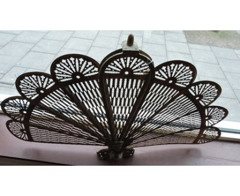 An empire style cast and pierced brass fan firescreen.