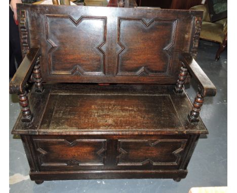 A 17th Century style carved oak monk's bench.