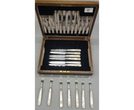 Oak canteen chest containing a set of 12 Mother of pearl handle and Sheffield silver forks and knives. Together with a set of